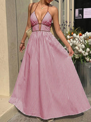 Burgundy striped halter maxi dress with plunging neckline and a-line skirt.