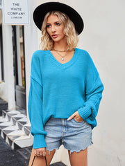 Oversized slouch knit v-neck sweater in bright blue, featuring a relaxed fit and ribbed cuffs.