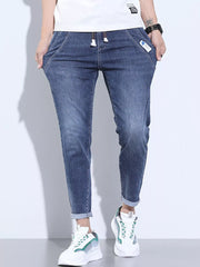 Washed skinny jeans in dark blue with adjustable drawstring and cuffed ankles.