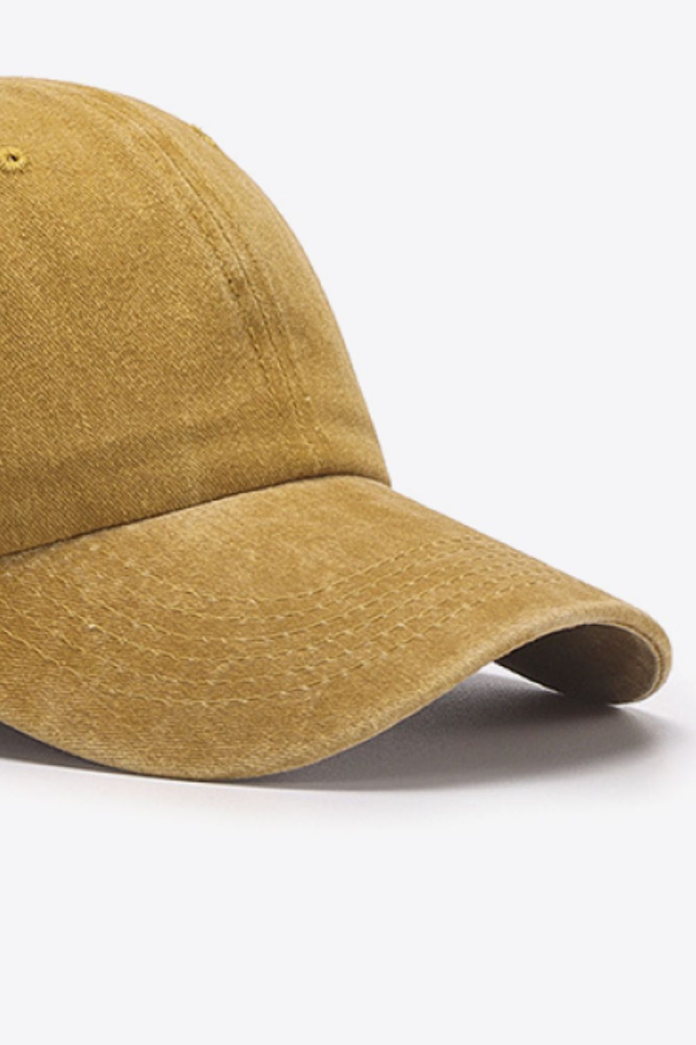 Washed cotton baseball cap in mustard with stitched detail on the brim.