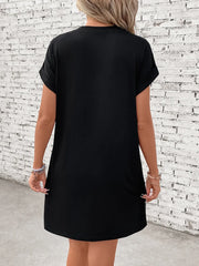 Black graphic tee dress with cuffed short sleeves and a casual fit.