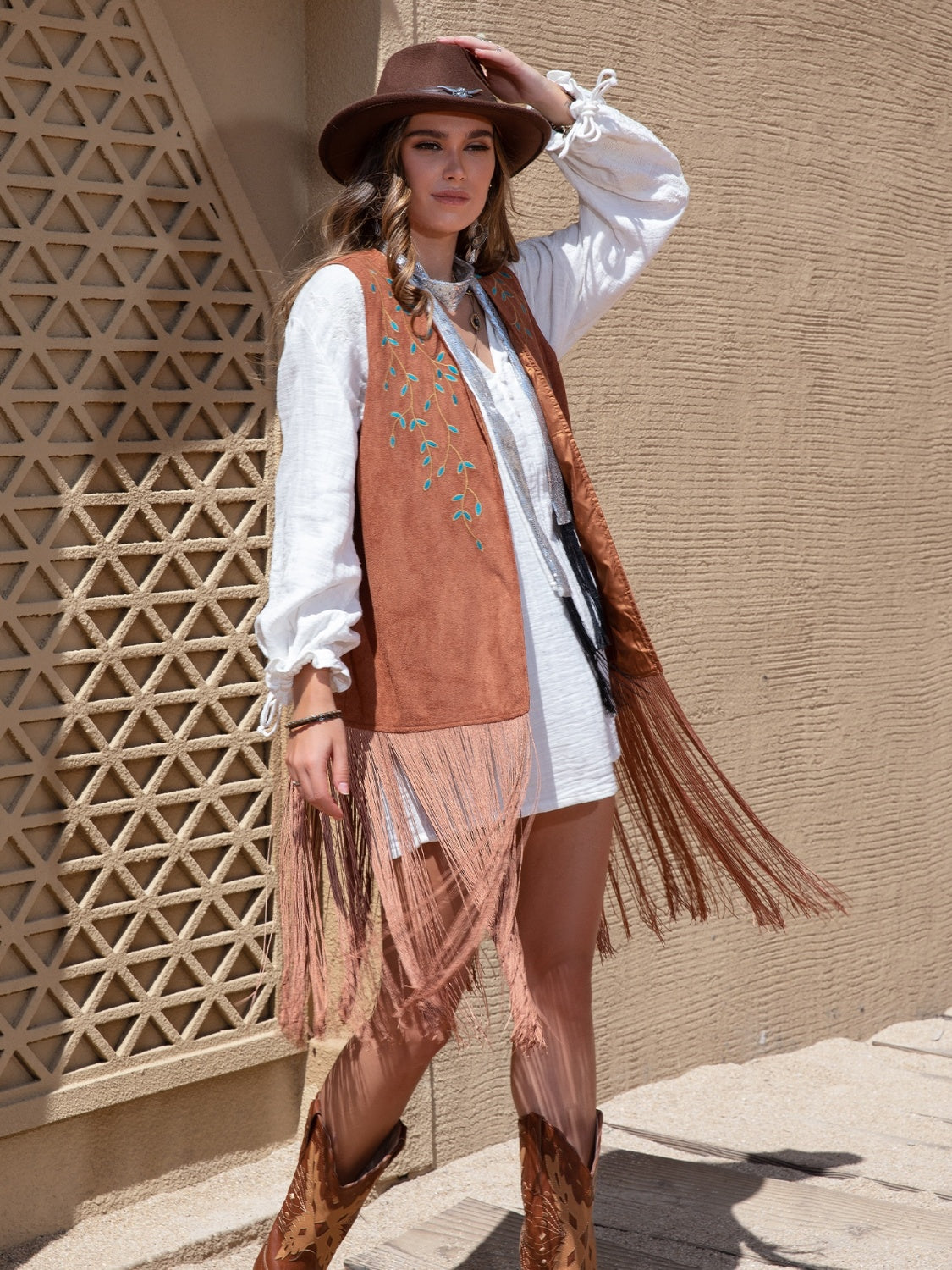 Faux suede fringe vest in terracotta with embroidered vine detail and long fringe.