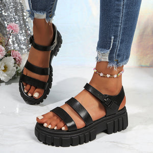Black open-toe platform sandals with three straps and buckle closure.