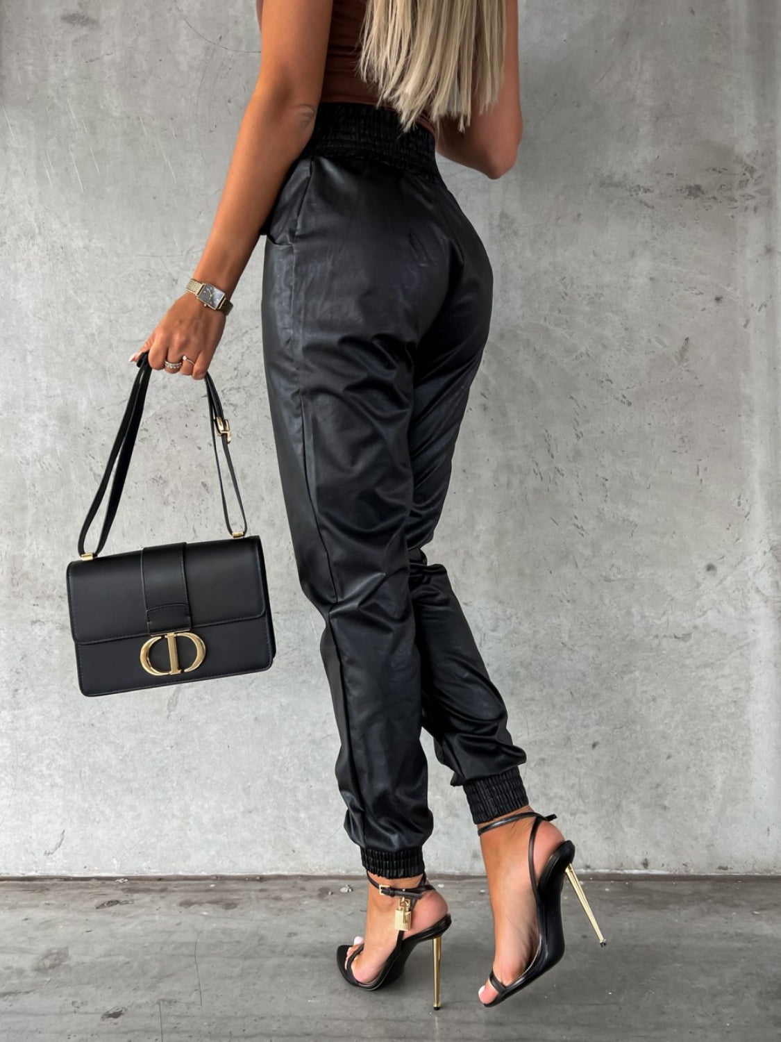 Black leatherette gathered waist joggers with cinched ankles.