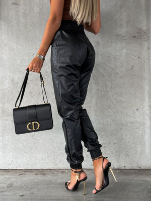 Black leatherette gathered waist joggers with cinched ankles.