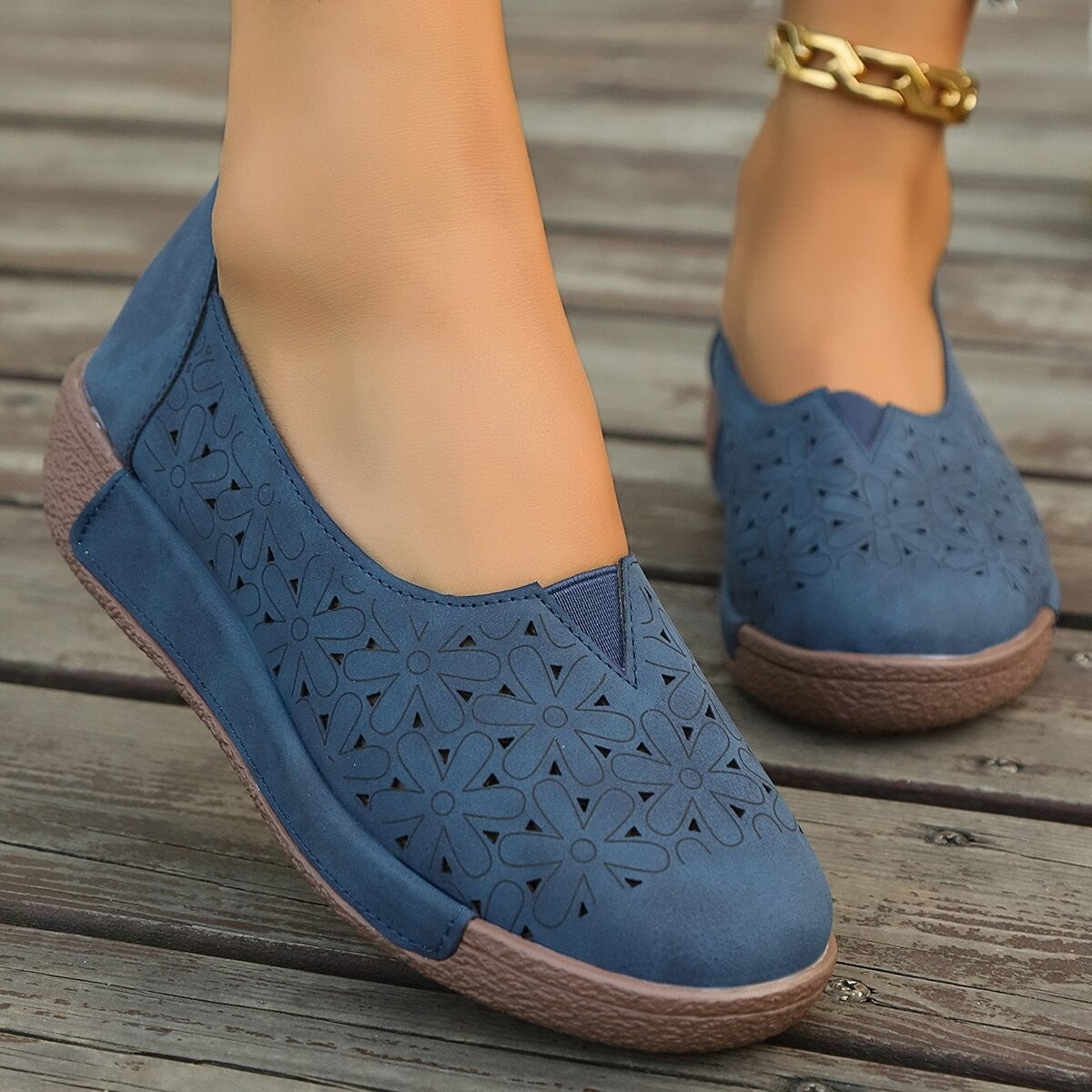 Blue floral cutout slip-on loafers with a comfortable, breathable design.