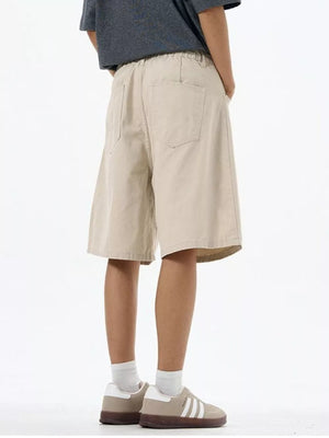 Light khaki chino shorts with drawstring waist and back pockets.