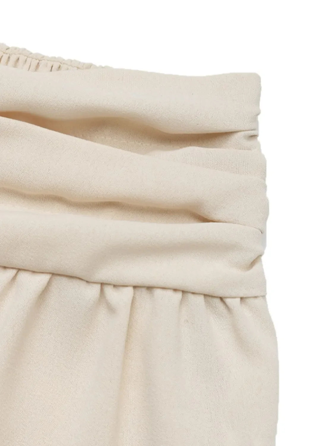 Cream ruched waistline balloon trousers with elasticated waistband detail.