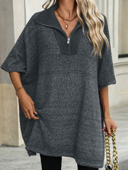 Dark gray knit zip-neck poncho with short sleeves and a ribbed collar.