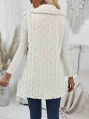 Beige textured sherpa button-down vest with cable knit pattern and fur trim collar.