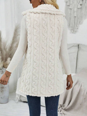 Beige textured sherpa button-down vest with cable knit pattern and fur trim collar.