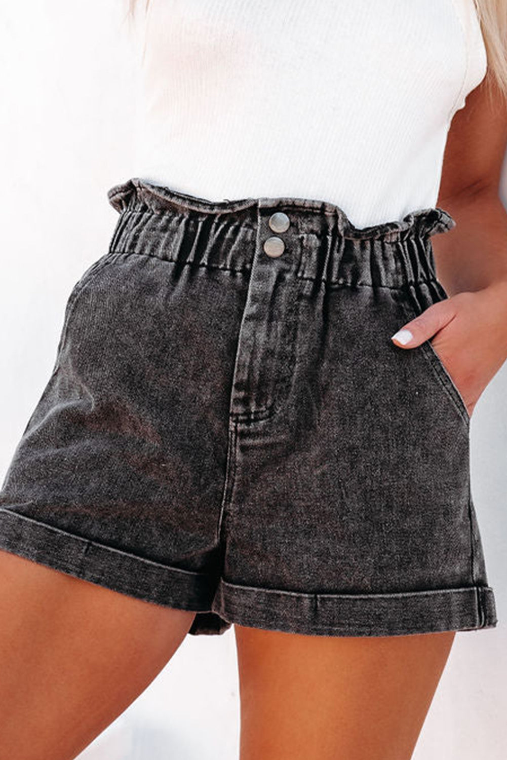 Washed dark denim paperbag cuff shorts with elastic waist and two button closure.