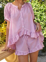Pink gingham ruffle-trimmed two-piece set with button-front top and drawstring shorts.