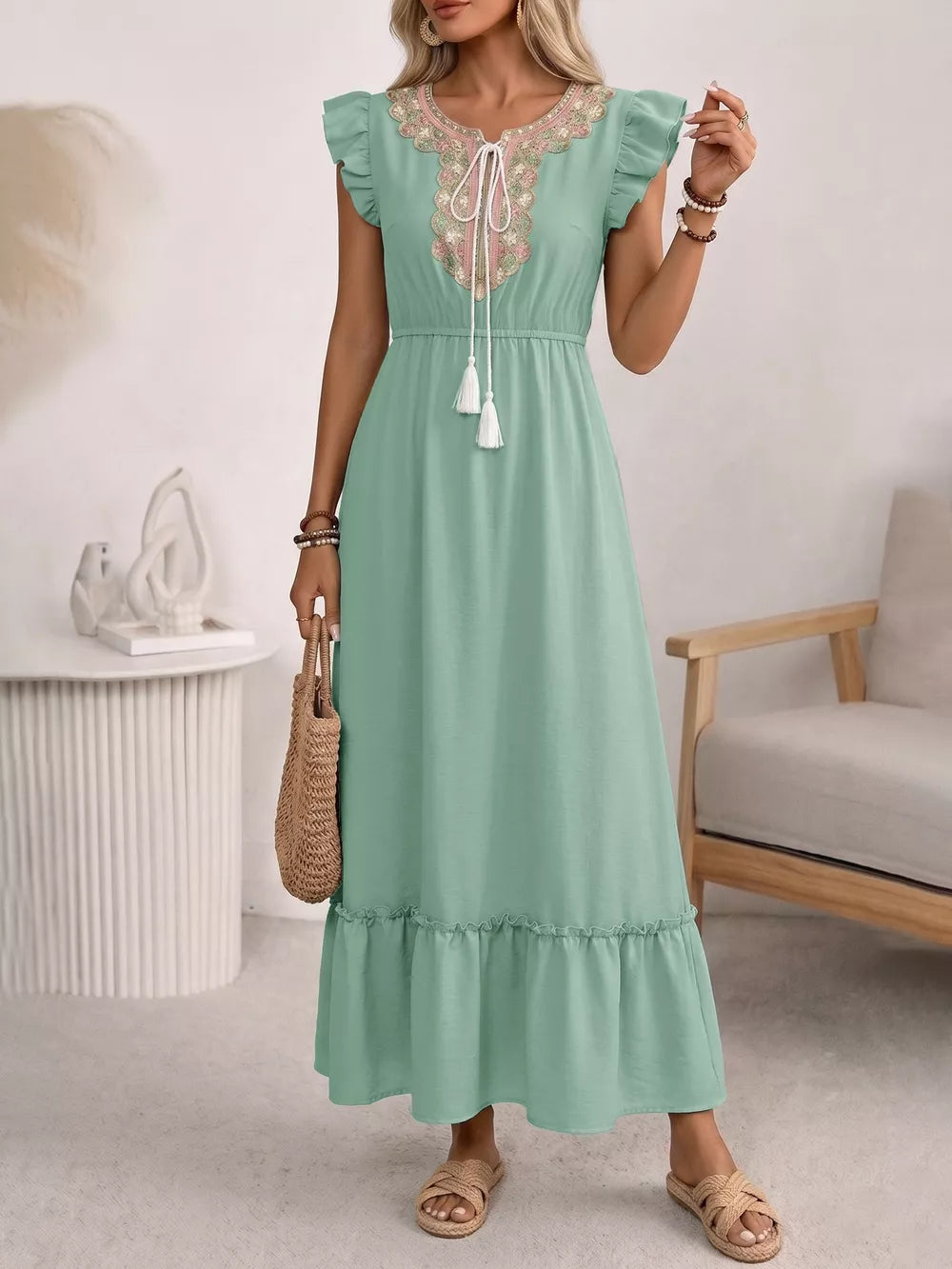 Maternity maxi dress in mint green with embroidered neckline, tie detail, ruffled sleeves and hem.