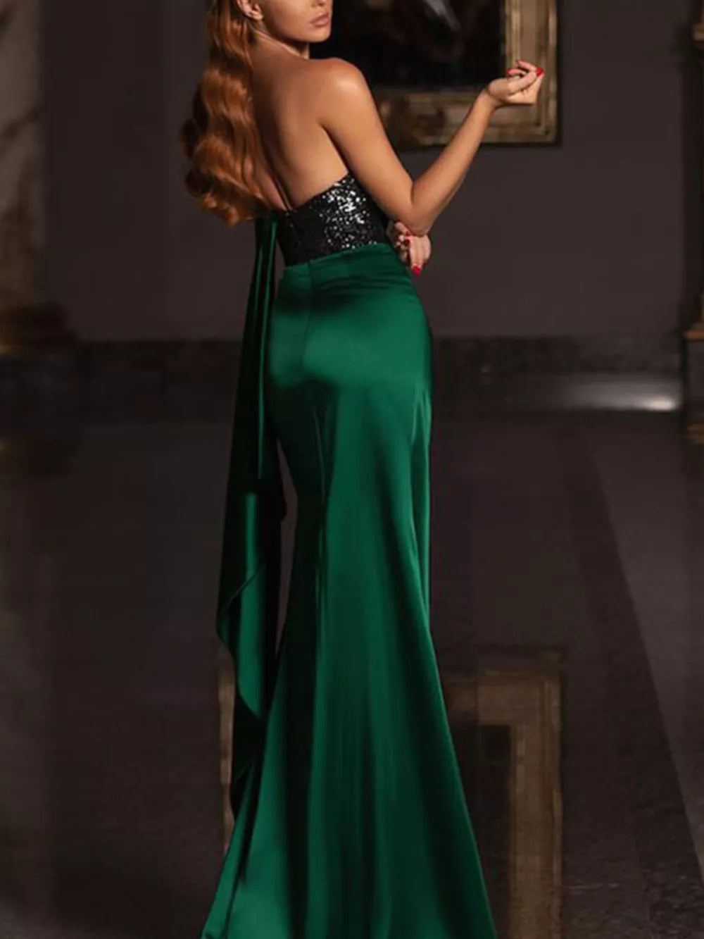 Green satin evening gown with asymmetrical sequin bodice and draped detail.