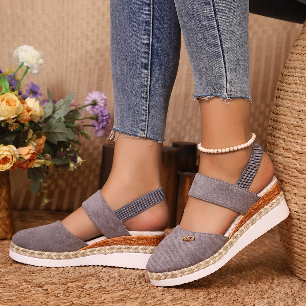 Gray espadrille wedge slingback sandals with elastic straps and braided jute detail.
