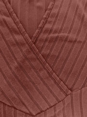 Ribbed wrap top in rust with a plunging neckline and vertical stripe texture.