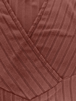 Ribbed wrap top in rust with a plunging neckline and vertical stripe texture.