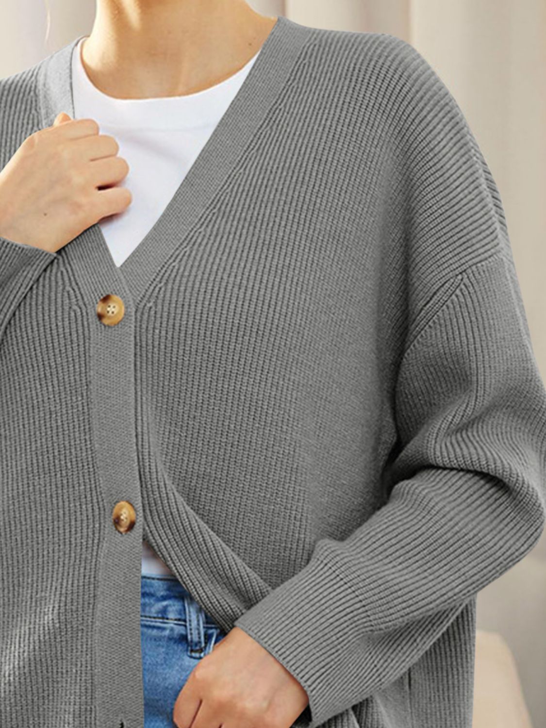 Gray ribbed knit cardigan with balloon sleeves and button front, styled with a white tee and jeans.