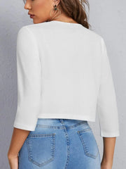 White cropped open-front blazer with elbow sleeves and a textured finish.