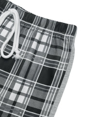 Plaid wide-leg track pants in black with white and grey plaid pattern and grey side stripe.