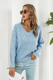 Light blue acrylic V-neck sweater with allover heart stitch pattern.