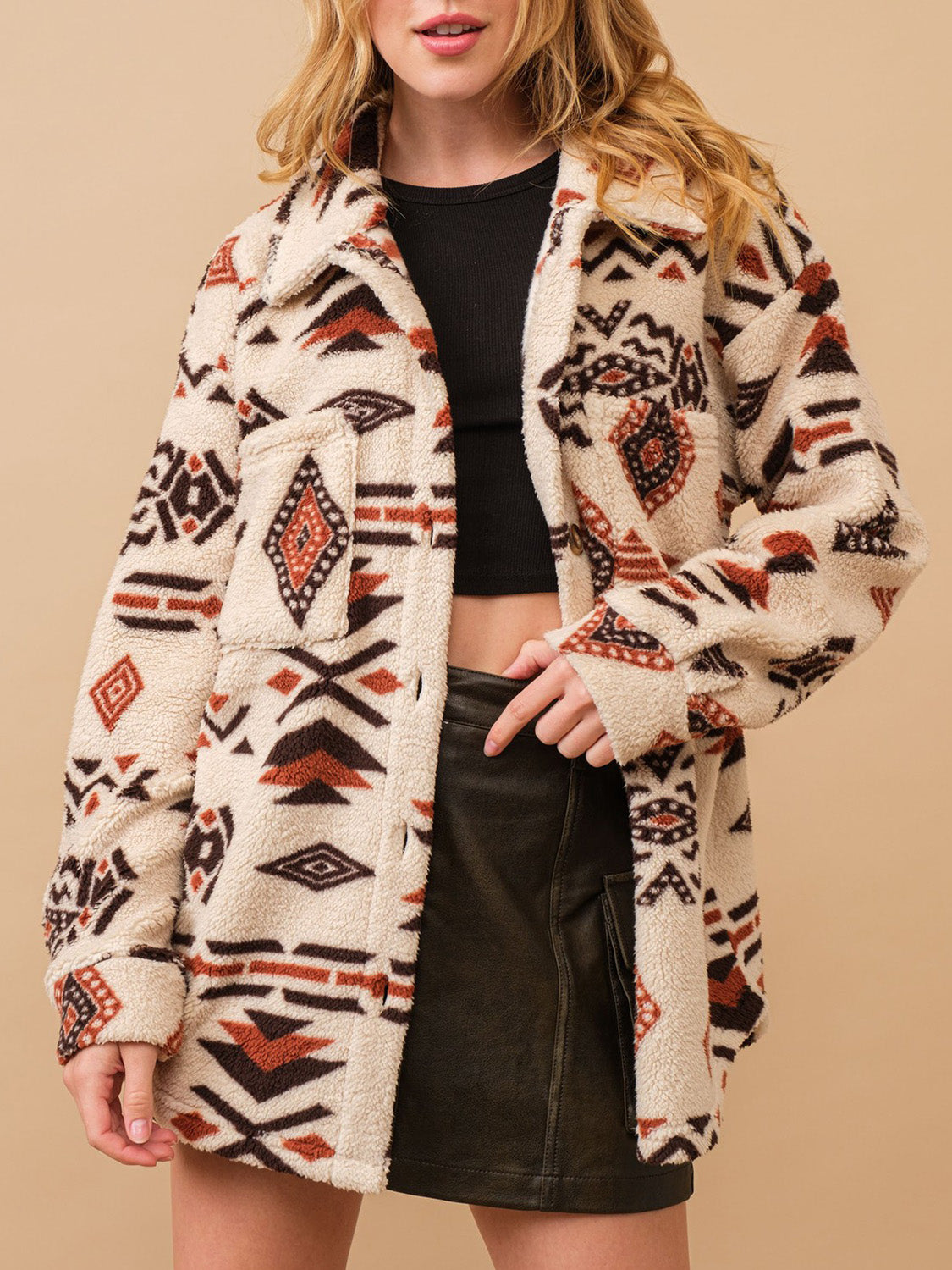 Beige sherpa overshirt jacket with bold Aztec pattern, button front and chest pockets.