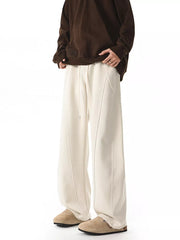 Men's plus size wide-leg pants in apricot with drawstring and seam detail.