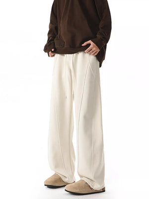 Men's plus size wide-leg pants in apricot with drawstring and seam detail.