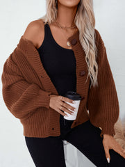 Brown chunky knit button-up cardigan with balloon sleeves and a relaxed fit.
