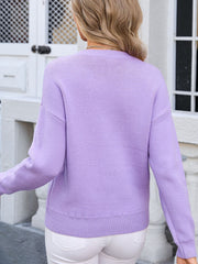 Lavender knit sweater with crew neck and long sleeves, featuring a subtle bow motif detail.