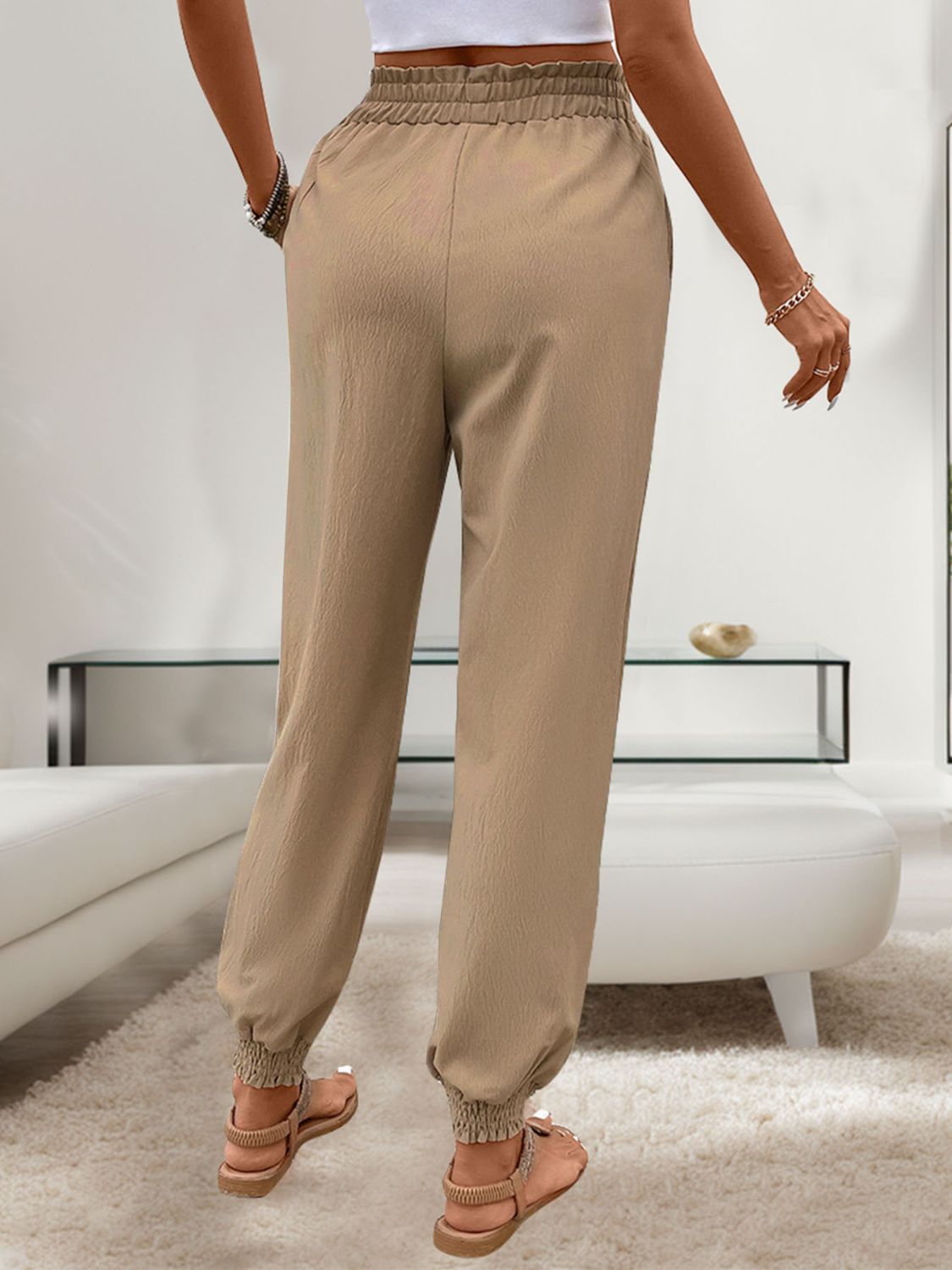 Tan linen-blend joggers with gathered cuffs and elastic waistband.