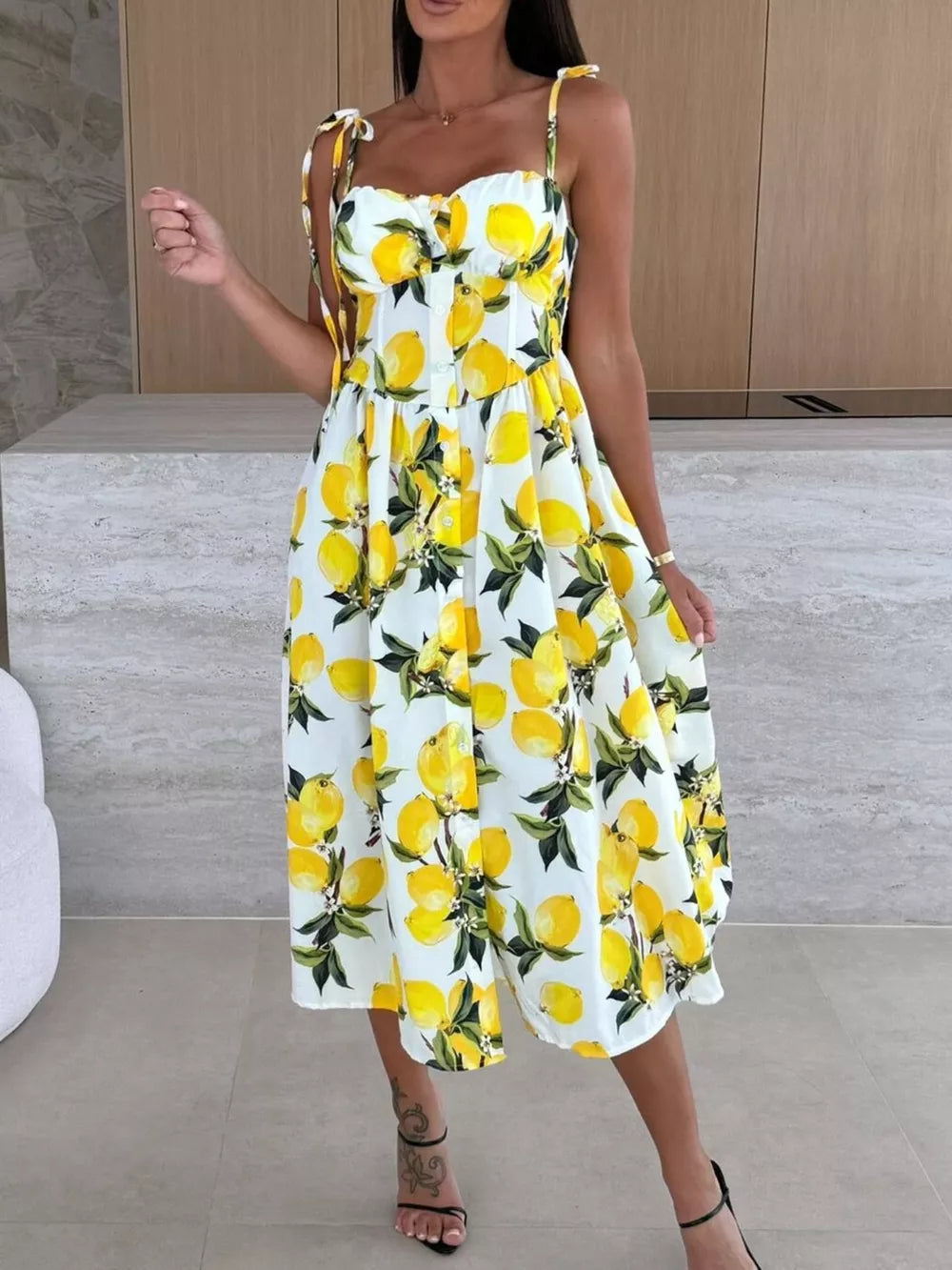 Floral tie-strap midi dress with a lemon print and button front.