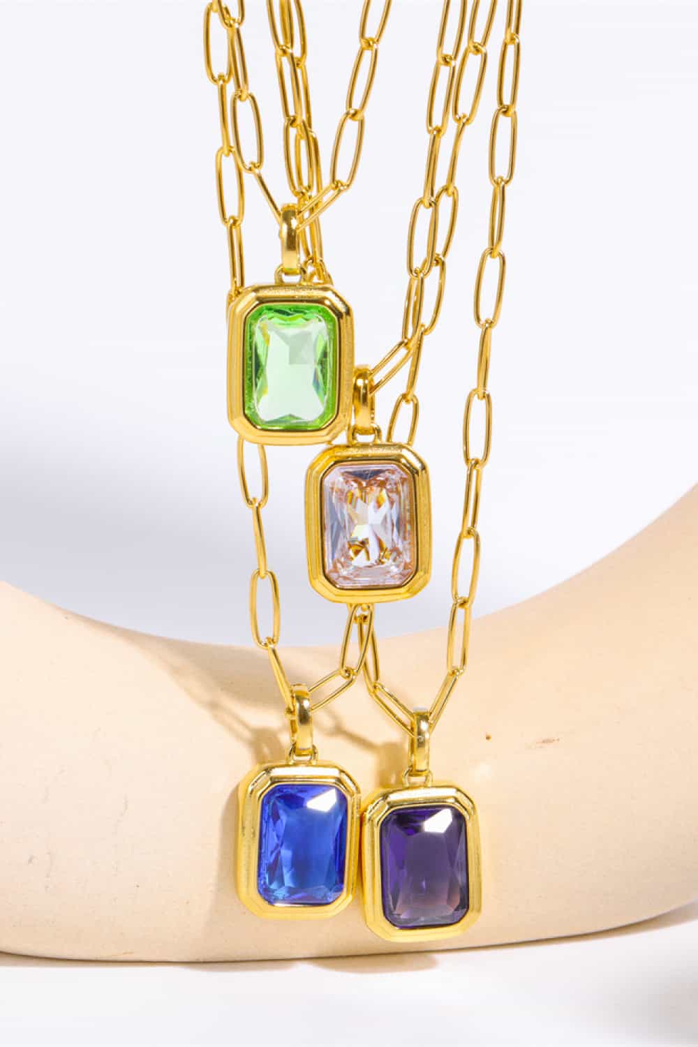 Gilded Prism Pendant Necklace with 18K gold chain and rectangular gemstone pendants in royal blue, purple, light green, and