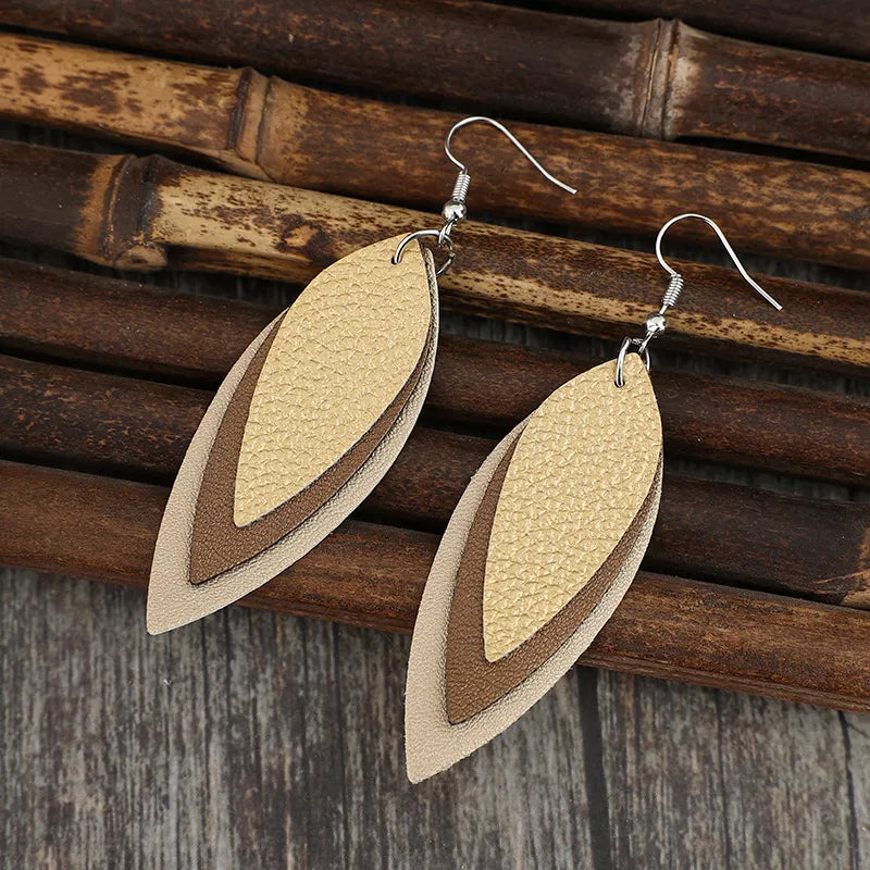 Layered tan leatherette statement earrings with hook backs.