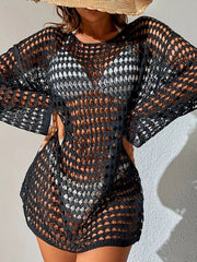Black open-knit beach dress with long sleeves and boatneck, worn over a white bikini.