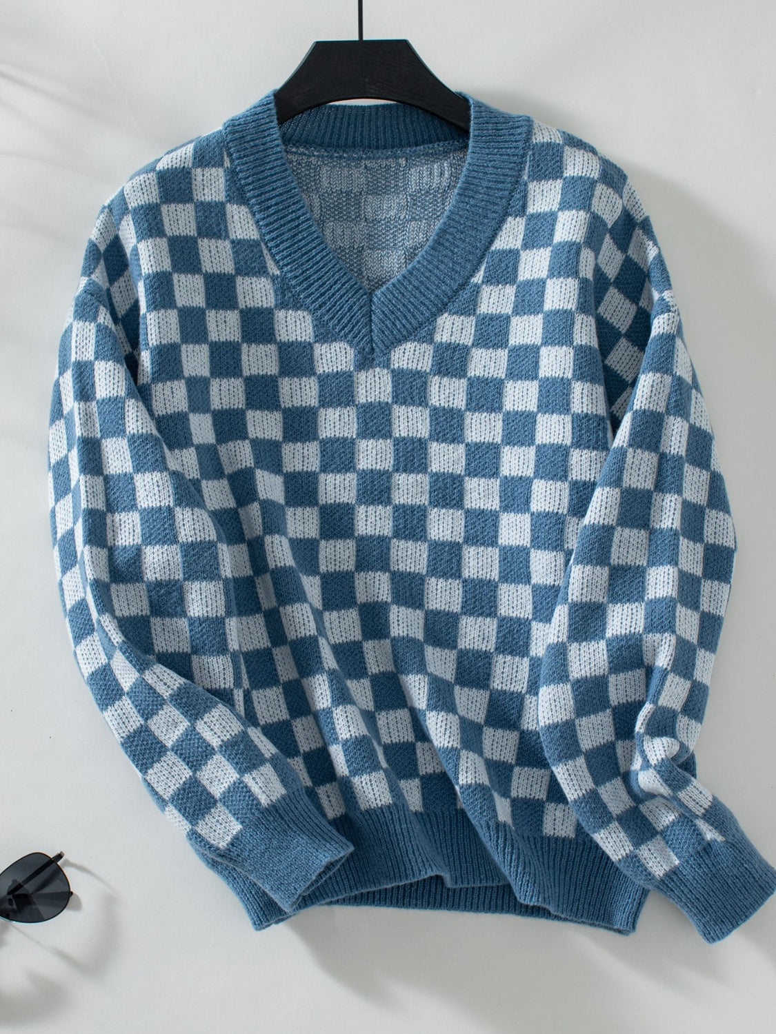 Checkerboard knit v-neck pullover sweater in dusty blue and white.