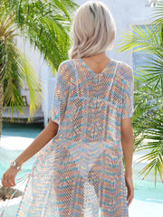 Openwork knit beach cover-up in pastel rainbow colors with V-neck and short sleeves.