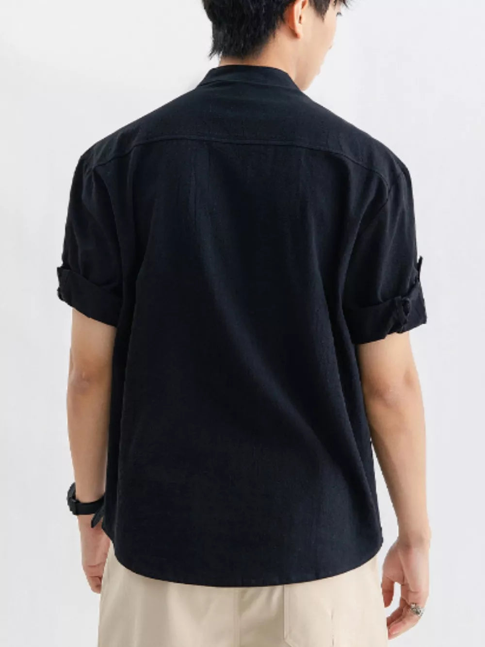 Black relaxed fit button-up shirt with rolled sleeves and a chest pocket.