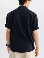 Black relaxed fit button-up shirt with rolled sleeves and a chest pocket.