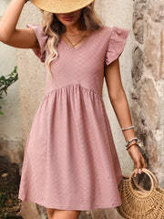 A-line dress in bean paste powder with ruffled sleeves and textured fabric.