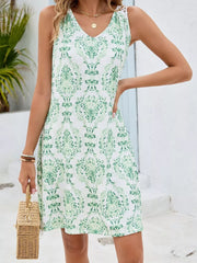 Green Flower botanical print mini dress with V-neck and crochet shoulder detail.