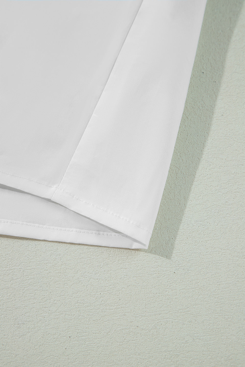 White piped trim bow blouse showing hem detail