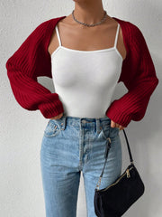 Burgundy acrylic knit bolero shrug with voluminous sleeves and ribbed cuffs, worn over a white cami.