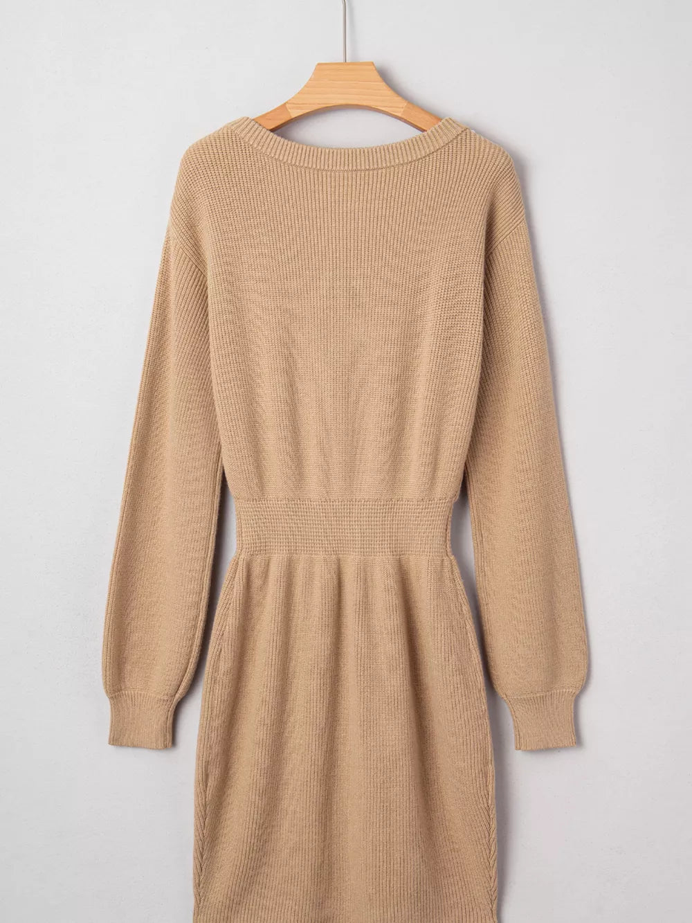 Tan ribbed knit sweater dress with long sleeves and a cinched waist.