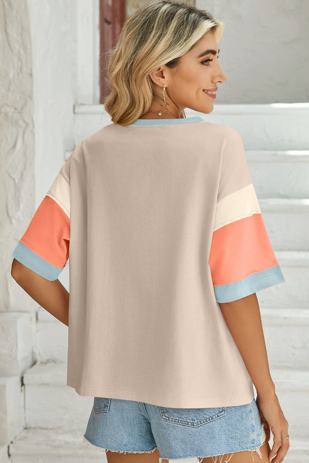 Panel sleeve crewneck tee in beige with colorblock sleeves featuring cream, coral, and light blue bands.