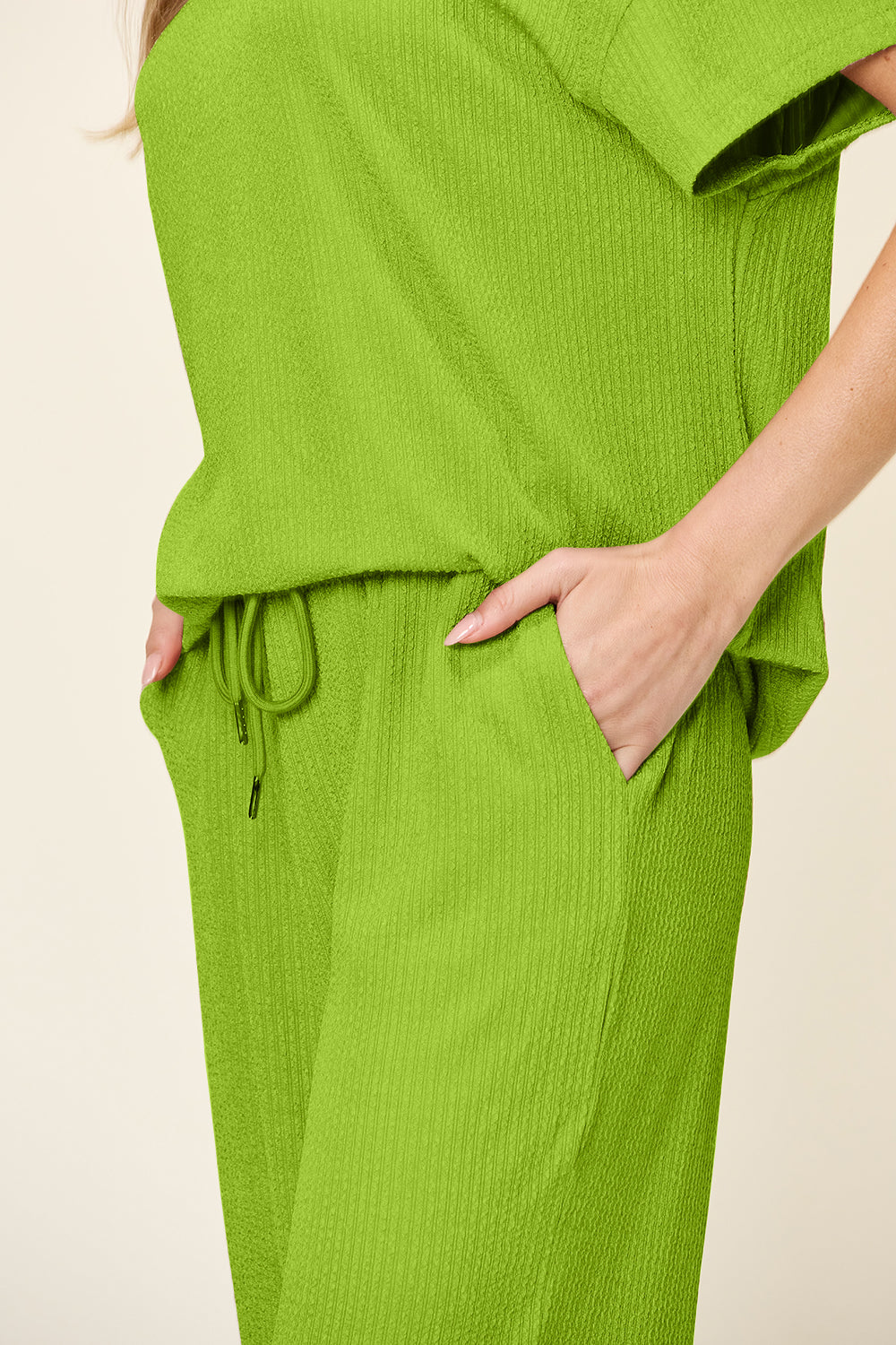 Lime green waffle knit lounge set with drawstring waist and pockets.