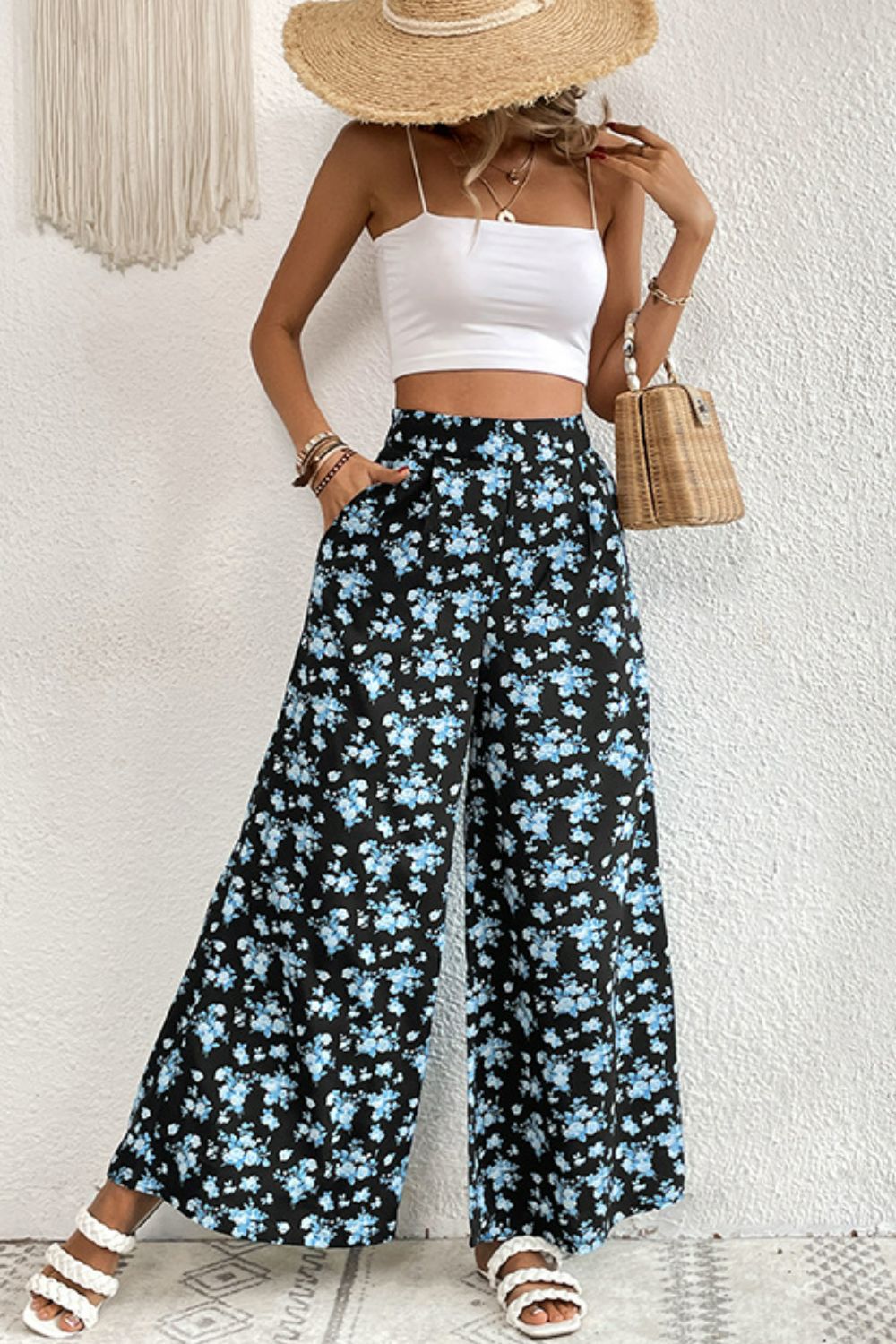 Midnight Floral Palazzo Trousers with a black base and blue floral print, featuring a wide leg and pockets.