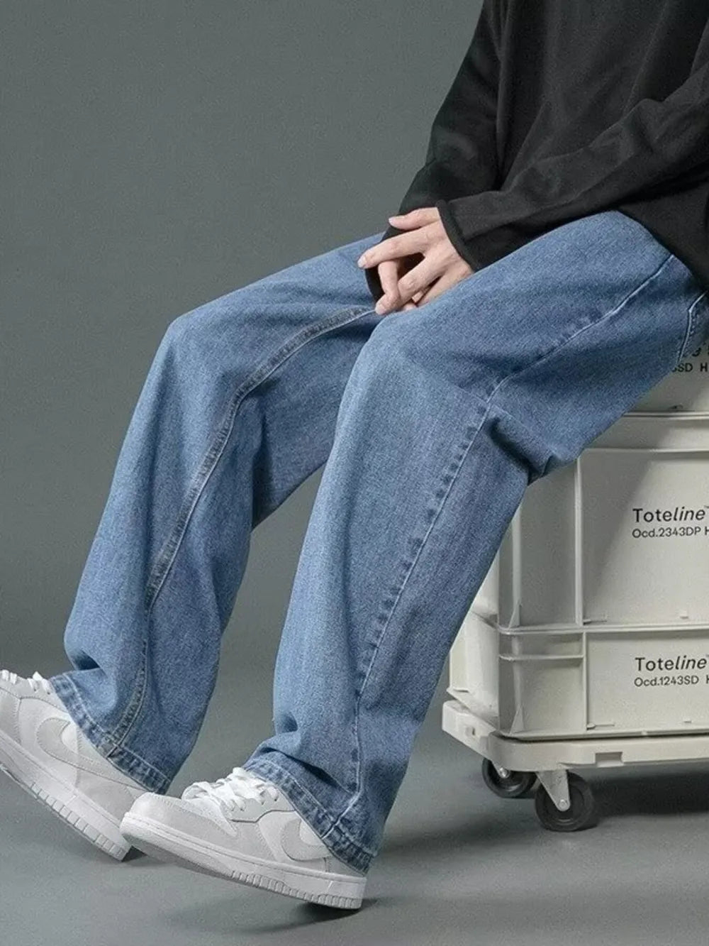 Men's light wash wide-leg jeans with a casual, relaxed fit.