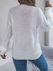 White cable knit balloon sleeve cardigan with textured sleeves.